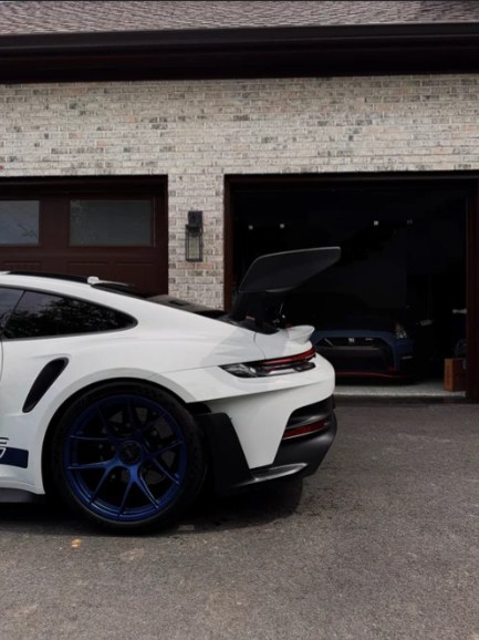 Rear of a white Porsche 911 GT3 RS with blue wheels, freshly detailed