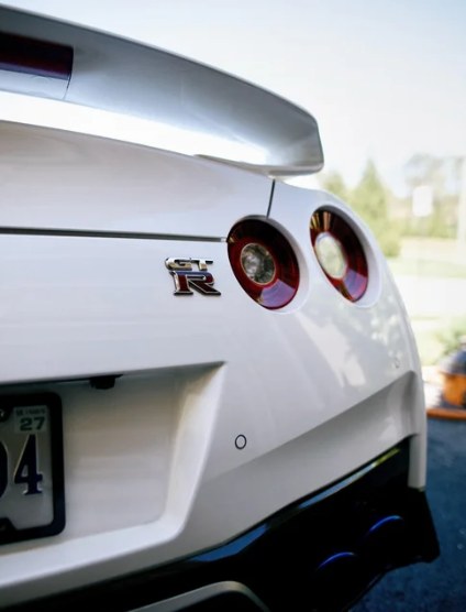 Rear of a white Nissan GT-R with a glossy, freshly detailed finish