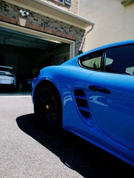 Blue Porsche Cayman with a freshly detailed, mirror-like finish